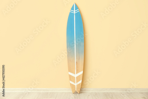 Wooden surfboard near beige...