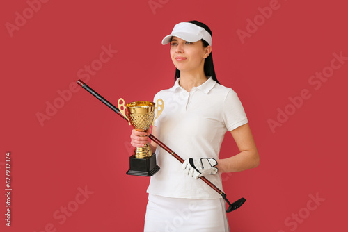 Female golfer with gold cup...