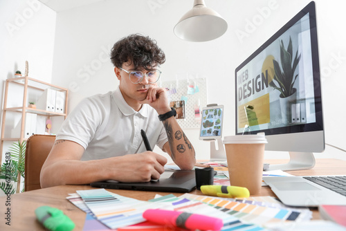 Male graphic designer worki...