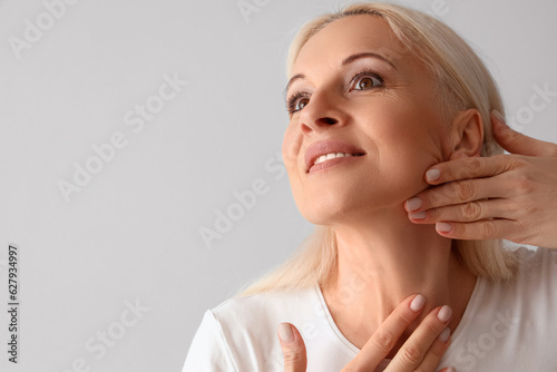 Mature woman doing face bui...