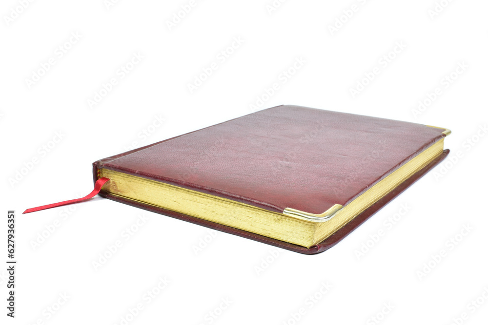 Dark red diary with ribbon isolated on white background. Close-up view Dark red diary with ribbon isolated on white background. Close-up view