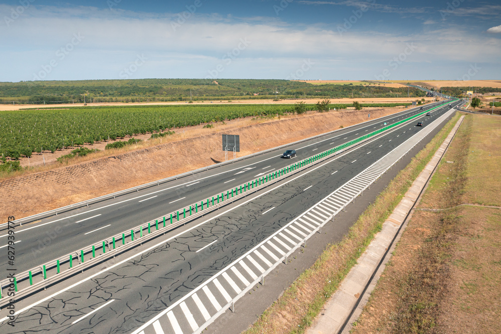 Highways of Romania. Aerial view of A2 highway road between Constanta and Bucharest, during a beautiful sunny day with blue sky. Infrastructure transportation industry in Romania.