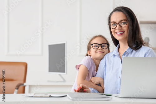 Smiling mother and daughter...