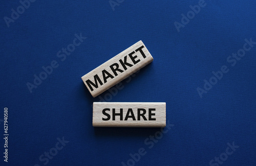 Market Share symbol. Wooden blocks with words Market Sharer. Beautiful deep blue background. Business and Market Share concept. Copy space.