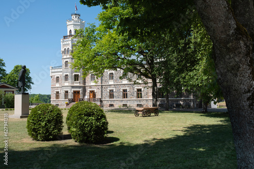Sigulda New Castle, built in 1878 in the Neo-Gothic style as the living house for the owners of the manor. Statue of Ata Kronwald photo