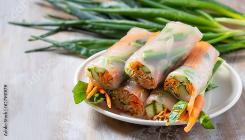 Vegan spring rolls with carrots, cucumber, green onions and rice noodles, selective focus photo