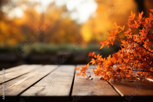 Wooden table with orange autumn leaves. Autumn background
