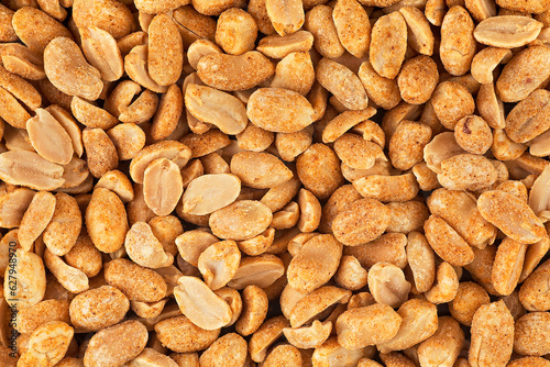 Roasted and salted peanuts as background, top view. Peeled and spicy peanuts.