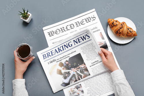 Woman reading newspaper wit...