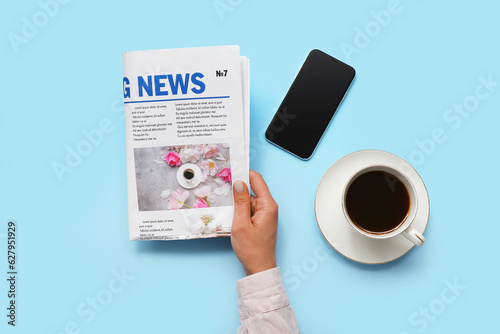 Woman reading newspaper wit...