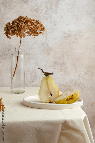 green pears on the edge of a beige kitchen table. Scandinavian s photo