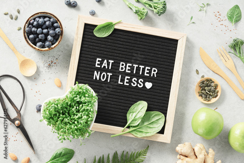Eat better not less letter board quote flat lay photo