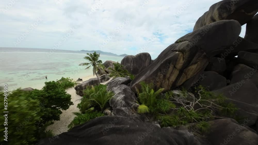 Fpv drone flying on a Anse Source d'Argent beach in Seychelles on an Island Mahe, video of incredible trees, Seychelles rocks, seaside, and surrounding Seychelles landscapes. Fpv drone flying on a Anse Source d'Argent beach in Seychelles on an Island Mahe, video of incredible trees, Seychelles rocks, seaside, and surrounding Seychelles landscapes.
