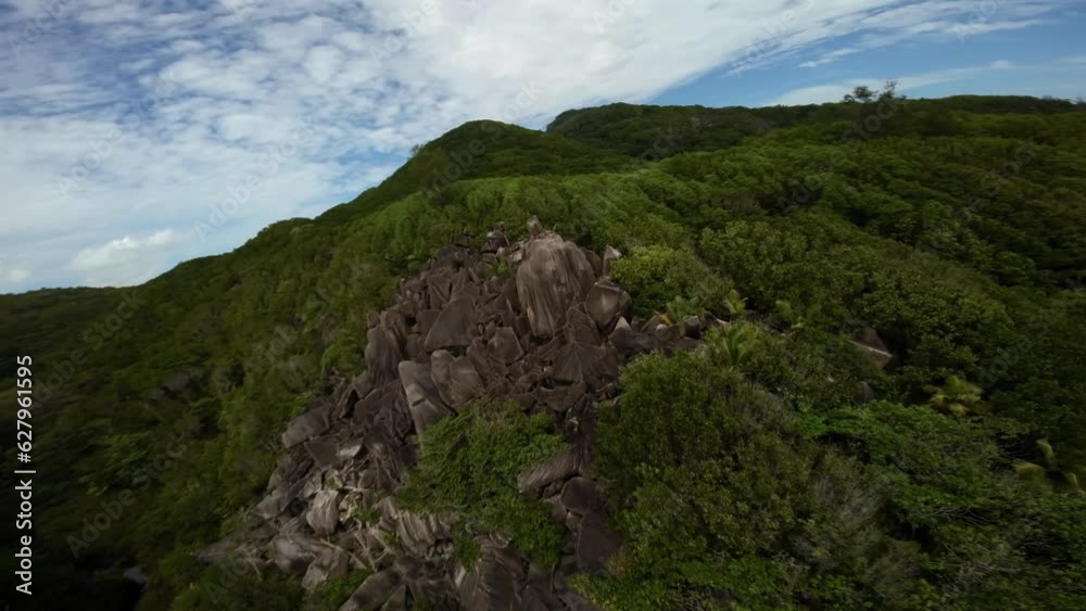 Fpv drone flying on a beach in Seychelles on an Island Mahe, video of incredible trees, Seychelles rocks, seaside, and surrounding Seychelles landscapes.