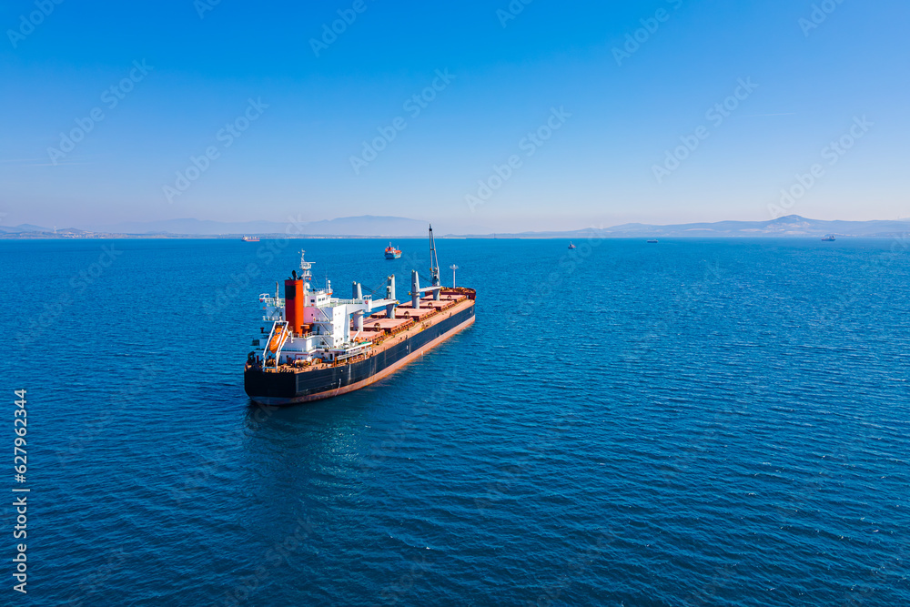 Bulk carrier ship anchored in Aegean sea waiting entering port, Aerial view