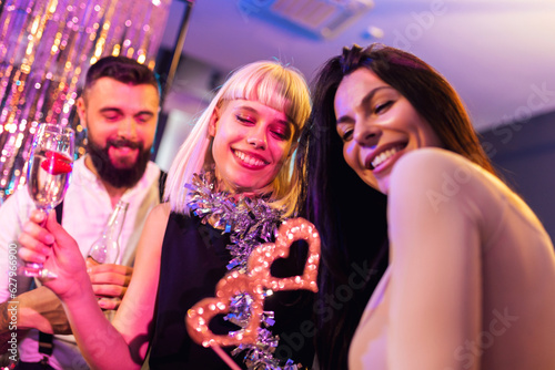 Group of people dancing in the club celebrating New Years