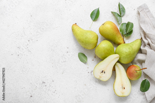 Ripe pears on white table photo