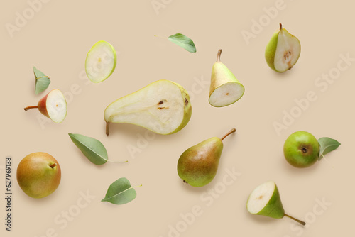 Flying ripe pears on beige background