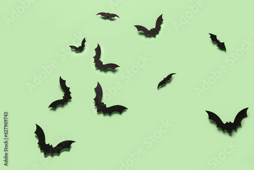 Paper bats for Halloween party on green background