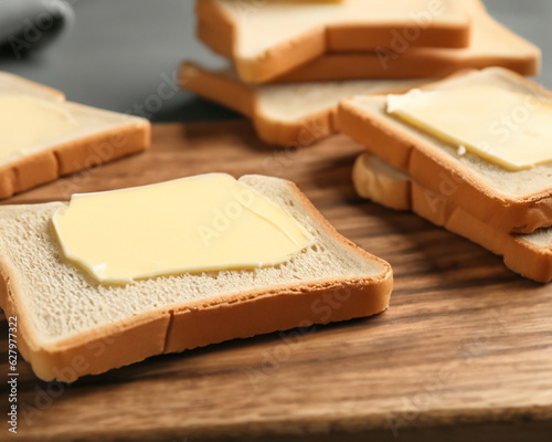 Cutting board with toasts and butter, closeup MADE OF AI