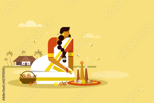 A traditionally dressed womanmaking floral designs on floor. Concept of Onam festival in Kerala