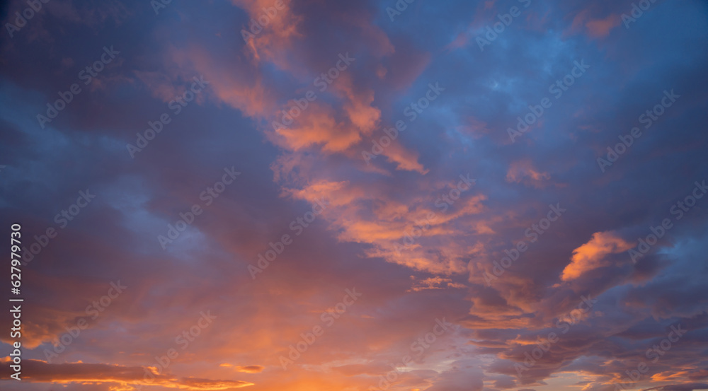 Sunset sky. Abstract nature background. Dramatic blue with orange colorful clouds in twilight time.