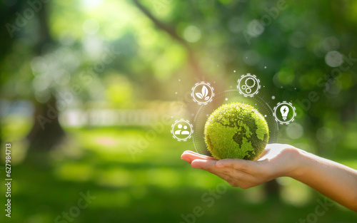 Photographie hand holding green earth Contains icons related to business, environment, circular economy concepts, production, waste, consumers, resources, life cycle assessment, LCA, sustainability