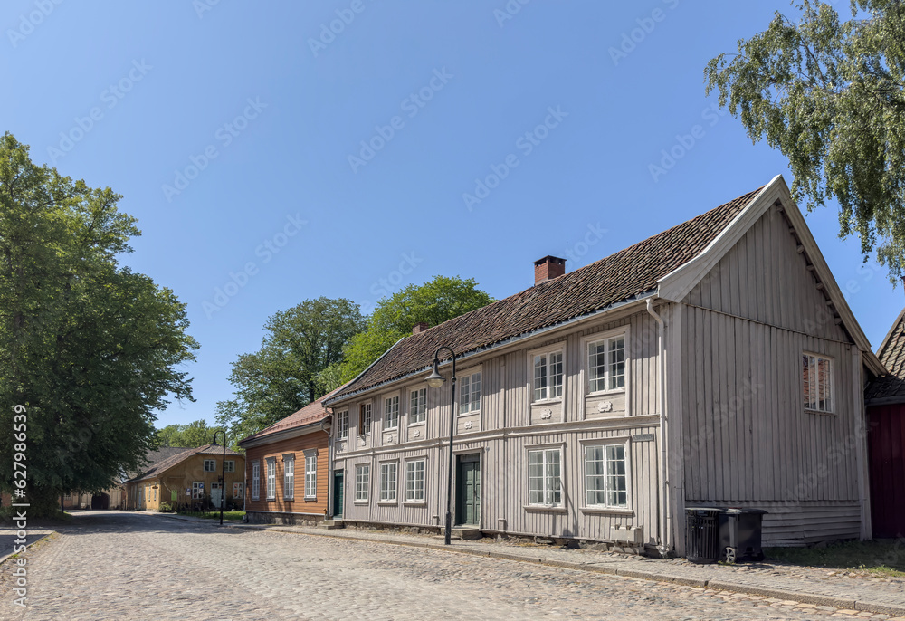 Happy walking in old Fredrikstad on a great warm summer day, with many old buildings, Norway	