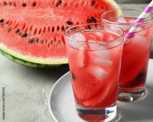 Homemade refreshing drink in glass and plate with watermelon slices on table MADE OF AI