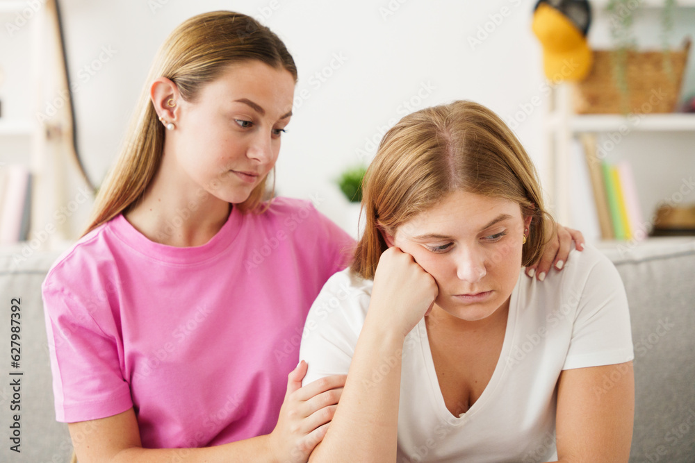 Young woman comforting worried sister Young woman comforting worried sister