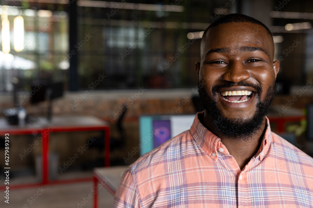 Portrait of a african american businessman smiling at modern office, copy space Portrait of a african american businessman smiling at modern office, copy space