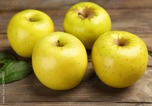 Ripe yellow apples on wooden table MADE OF AI