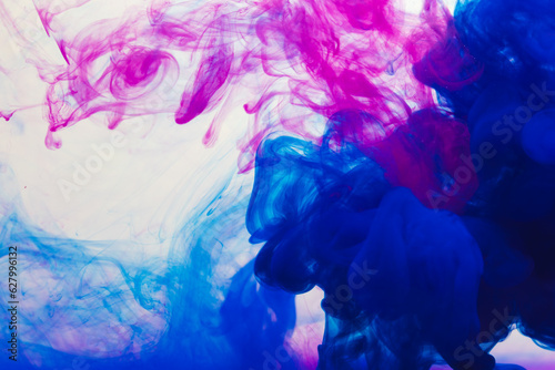 Close up of blue and pink ink in water with copy space on white background
