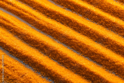 Close up of pattern of orange sand and copy space background