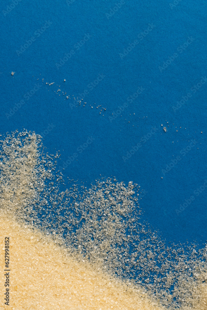 Close up of sand grains and copy space on blue background