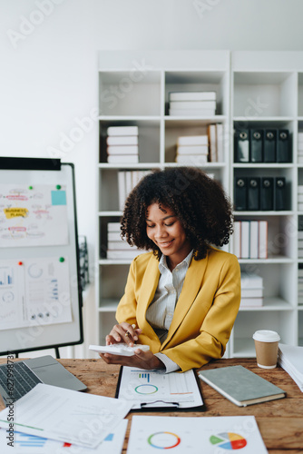Young asian female work with financial papers at home count on calculator before paying taxes receipts online, planning budget glad to find chance for economy saving money, audit concepts.
