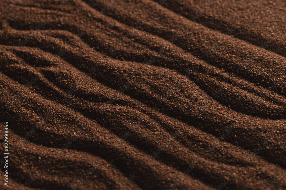 Close up of pattern of brown sand and copy space background Close up of pattern of brown sand and copy space background