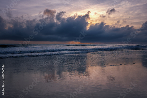 Wave approaching a beach at dawn