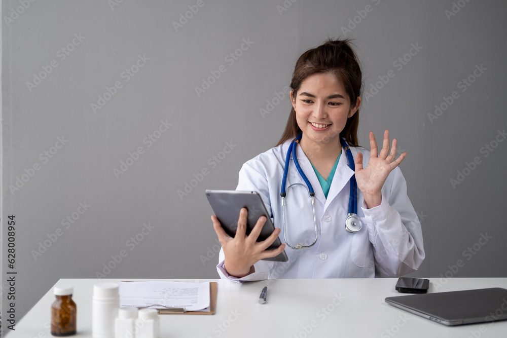 Female Young Asian doctor making video call with patient by smartphone cell phone laptop tablet Female Young Asian doctor making video call with patient by smartphone cell phone laptop tablet