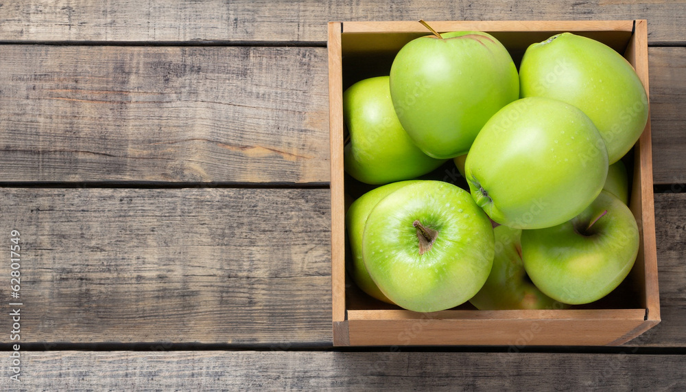 Ripe green apples box on wooden table. Top view with space for your text Ripe green apples box on wooden table. Top view with space for your text