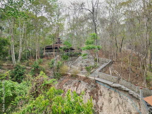 A Buddhist temple in the middle of a forest by the Bamboo Bridge in Pai, Thailand. photo