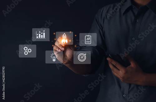 Businessman with transparent rocket with network connection launch icon on modern virtual interface.