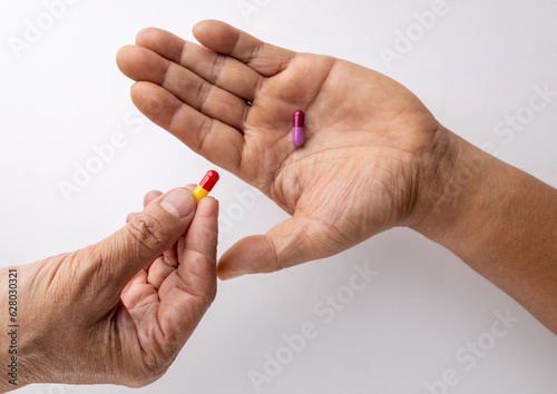 Four pill capsules  in the hand.