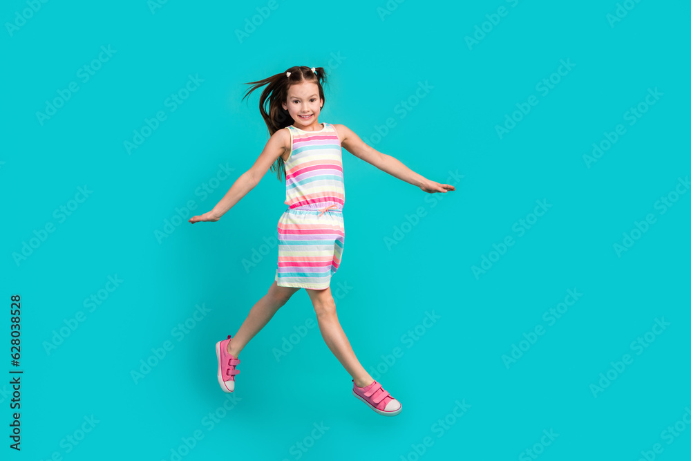 Full length photo of adorable positive girl wear stylish clothes have fun go store summer seasonal offer isolated on blue color background
