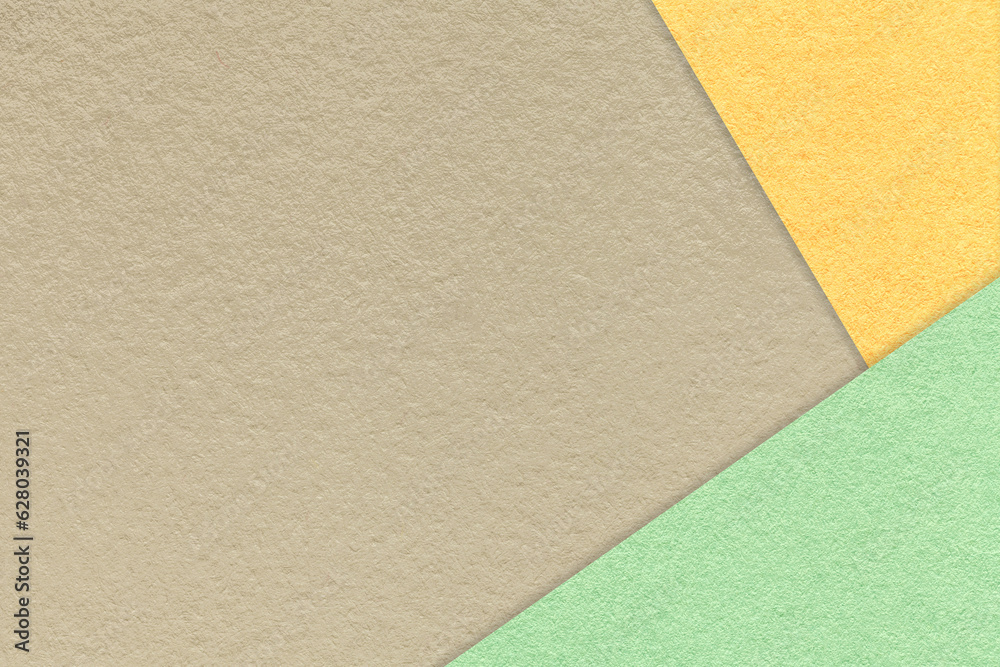 Texture of craft beige color paper background with yellow and green border. Vintage abstract light brown cardboard. Texture of craft beige color paper background with yellow and green border. Vintage abstract light brown cardboard.