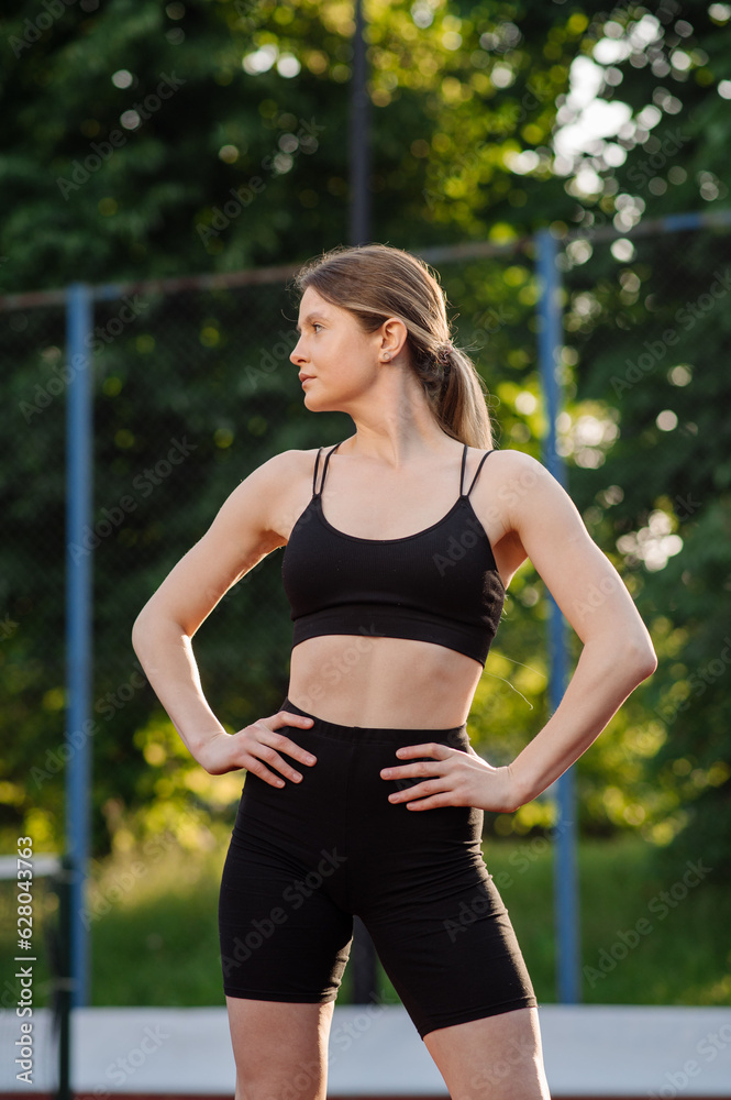 Caucasian sports woman doing warming exrcises outdoors on the sports ground Caucasian sports woman doing warming exrcises outdoors on the sports ground