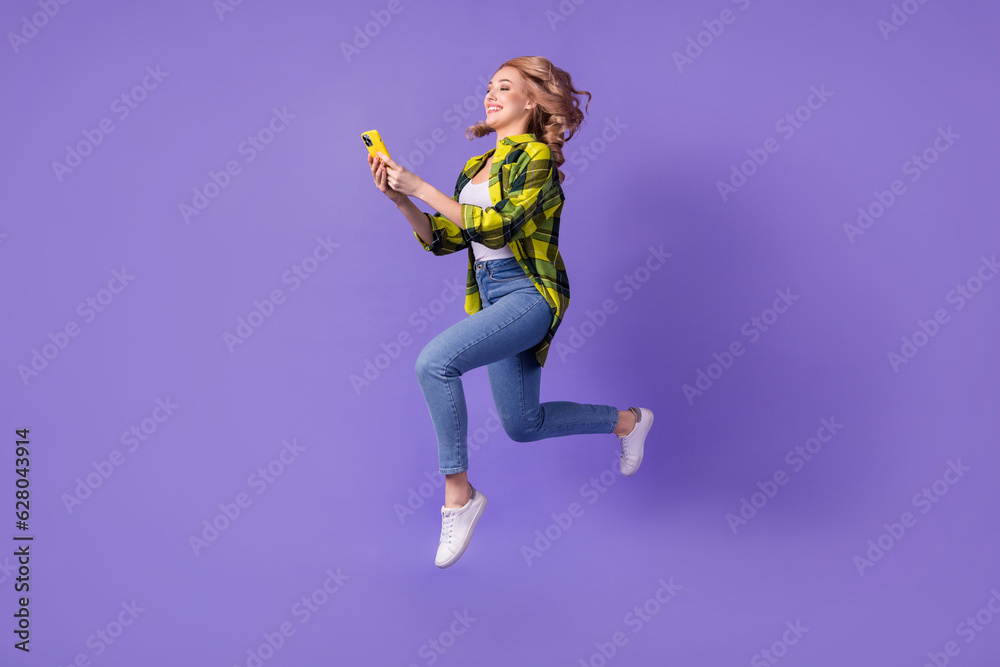Full body photo of funny blogging jump woman run with samsung iphone record video instagram broadcast isolated on violet color background