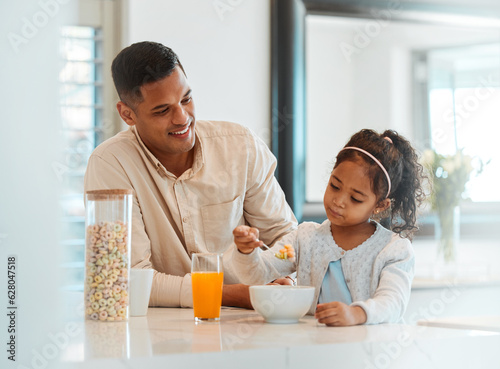 Happy  morning and a child with father for breakfast  food in a kitchen and care for nutrition at home. Smile  together and a young dad with a girl kid eating cereal in a house for health and hungry