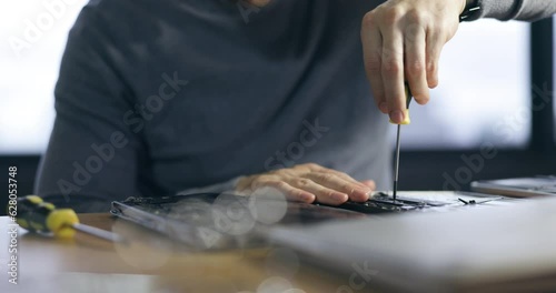 Hardware, maintenance and hands of man in office for technician, programming and engineer. Developer, tools and electrician with closeup of employee for technology, handyman and laptop repair photo
