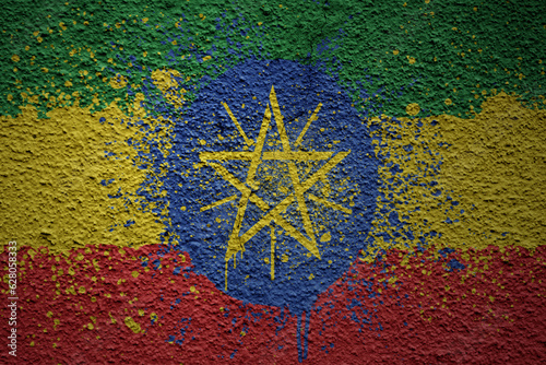 painted big national flag of ethiopia on a massive old cracked wall
